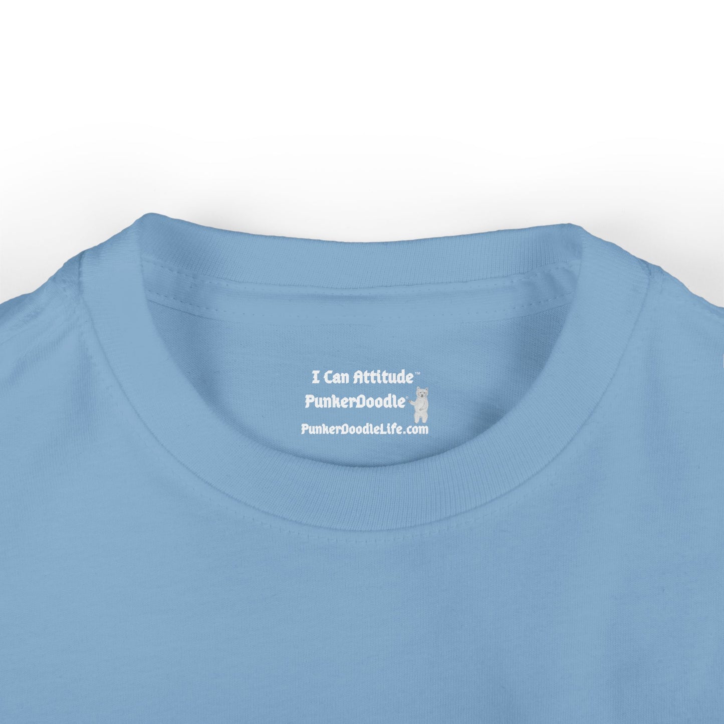 Close-up of I Can Attitude™ and PunkerDoodle® neck label inside blue infant T-shirt with brand website